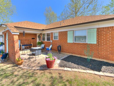 Back of house with a patio area, brick siding, and