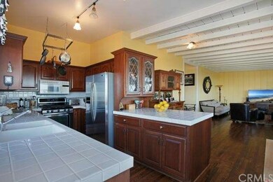 KITCHEN ADJACENT TO DINING AREA AND OUTDOOR DECK