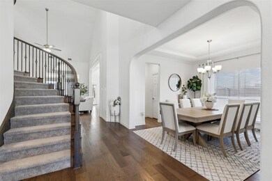 Dining space with ceiling fan with notable chandel