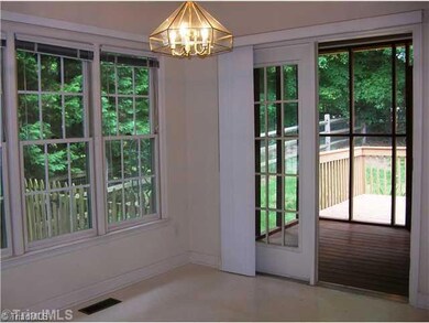 Breakfast. The Great Room opens to the dining area and out to a screened porch and deck-- also notice the fenced yard in this picture.
