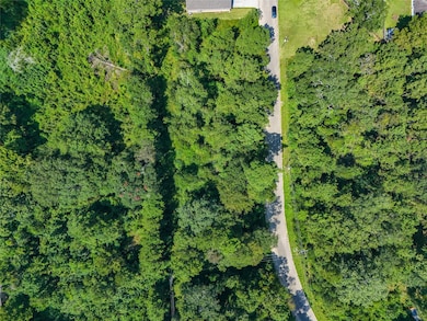 Aerial perspective showing the property’s depth and tree coverage.