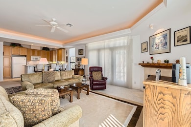 Living area with visible vents, crown molding, ce