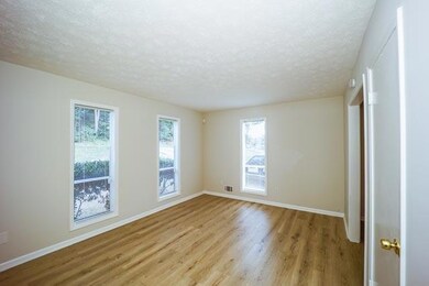 Spare room featuring a textured ceiling and light 