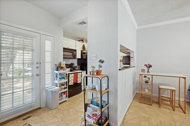 Kitchen featuring electric range oven, crown mold
