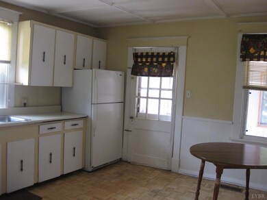 Refrigerator and stove convey. This door leads to the 3 season porch where you will find washer/dryer hookups.