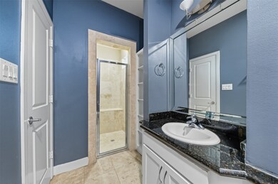 With its own bath, the downstairs bedroom is a convenient option for guests or long-term stays.