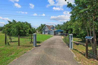 View of front of house with a detached carport an