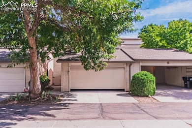 View of front facade featuring concrete driveway and stucco siding