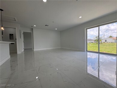 Spare room featuring light marble finish floors an