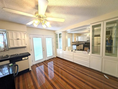 Kitchen with black range with electric stovetop, f