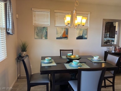 Dining room featuring wood finished floors, a chandelier, and healthy amount of natural light