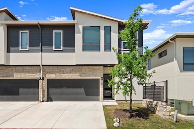 Modern home with an attached garage, driveway, st