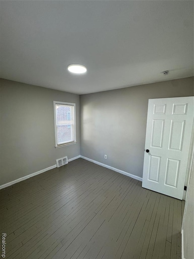 Unfurnished room featuring hardwood / wood-style floors