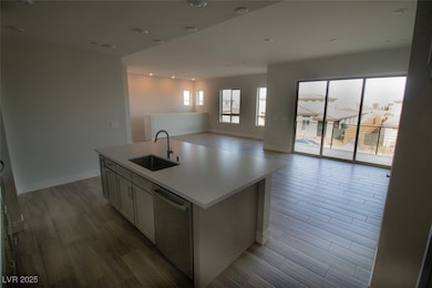 Kitchen with dishwasher, a sink, open floor plan,