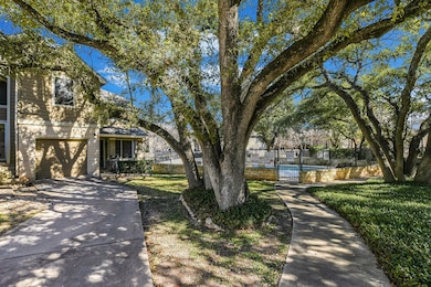 View of home's community featuring concrete driveway and a swimming pool