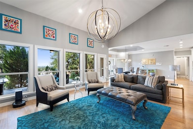 Living area featuring a chandelier, high vaulted 