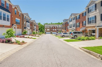 View of asphalt street featuring a residential view and curbs