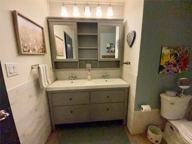 Full bathroom featuring double vanity and toilet