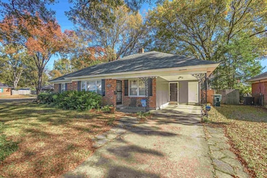 Single story home featuring a front lawn and a por