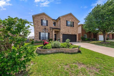 Traditional home with a garage, a front yard, dri
