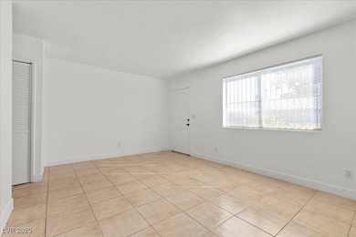 Empty room featuring light tile patterned floors