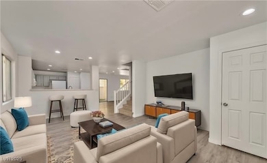 Living room featuring light wood-style flooring, v