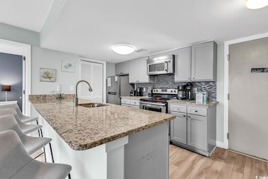 Kitchen with tasteful backsplash, sink, a kitchen 