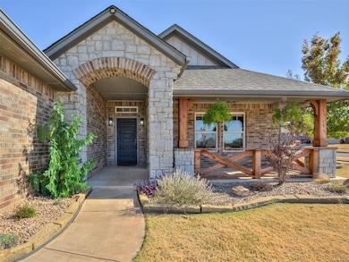 View of exterior entry featuring brick siding, board and batten siding, roof with shingles, and a lawn