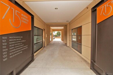 A secured building with retail spaces at the botto