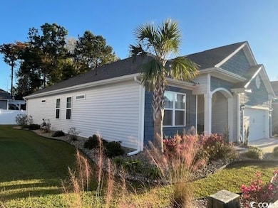 View of side of property featuring a garage and a 