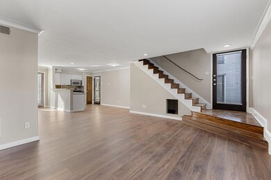 Foyer featuring ornamental molding, baseboards, wo