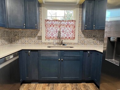 Kitchen with sink, light hardwood / wood-style flo
