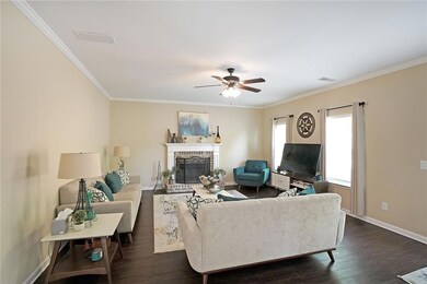 Living area featuring baseboards, a ceiling fan, d