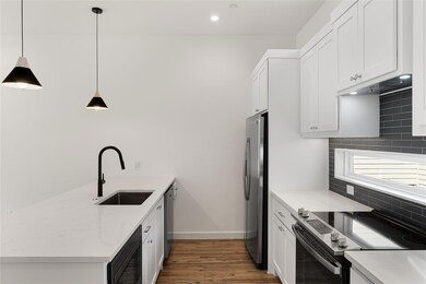Kitchen featuring decorative light fixtures, dark 