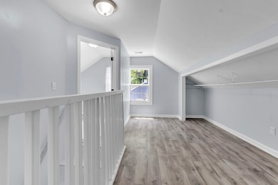 Additional living space featuring lofted ceiling, 