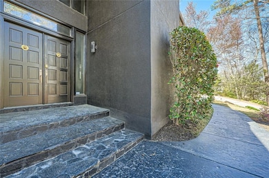 View of exterior entry with stucco siding