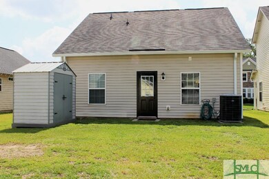 Nice backyard with a storage shed that stays with 