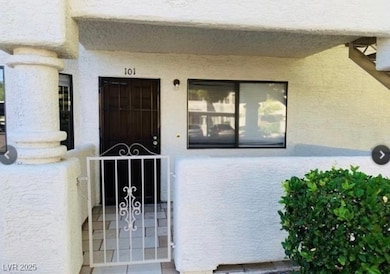 Property entrance with a gate and stucco siding