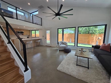 Living area with finished concrete flooring, rece