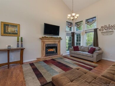 Bright living room with high ceiling and gas firep