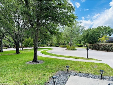 View of community with a lawn and view of wooded area