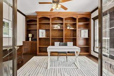 Through the French doors, enter your office/study finished with Crown molding and custom built-ins.