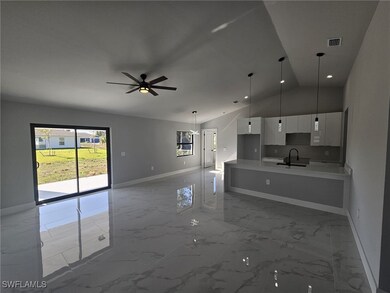Kitchen featuring pendant lighting, white cabinets