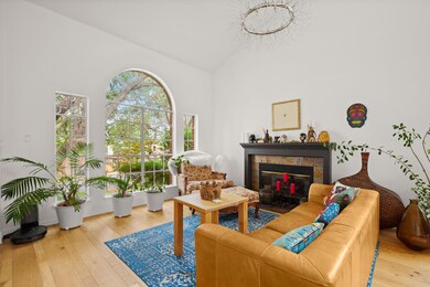 Living area featuring a tiled fireplace, lofted c