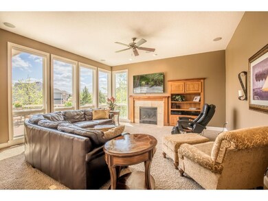 Family room offers tile surround gas fireplace wit