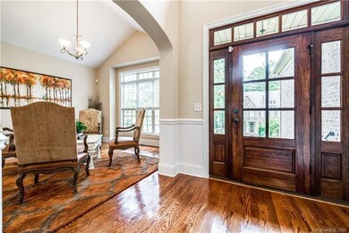 Grand foyer entry with on-site finished wood floor