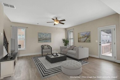 Living area featuring light wood finished floors and ceiling fan