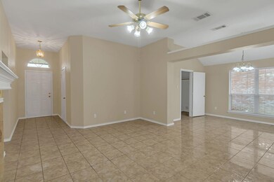 Empty room with visible vents, ceiling fan with no