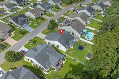 Aerial view of property's location featuring nearby suburban area and a pool
