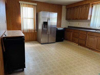 Kitchen featuring sink, stainless steel fridge, an